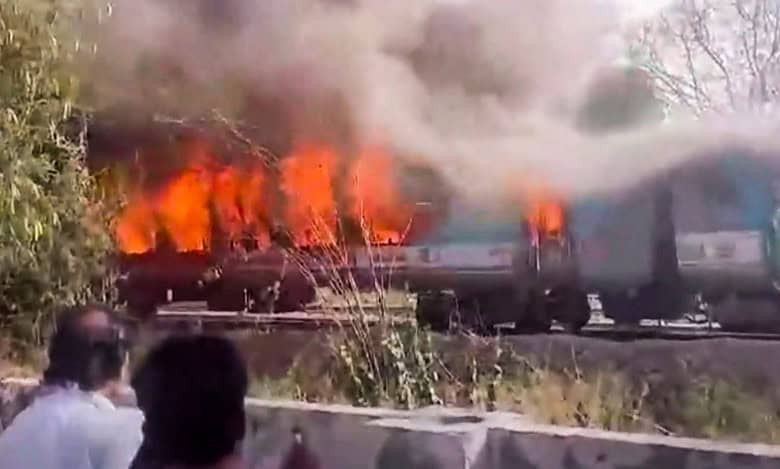 A firefighter inside a charred coach of the Taj Express after a fire broke out in the train
