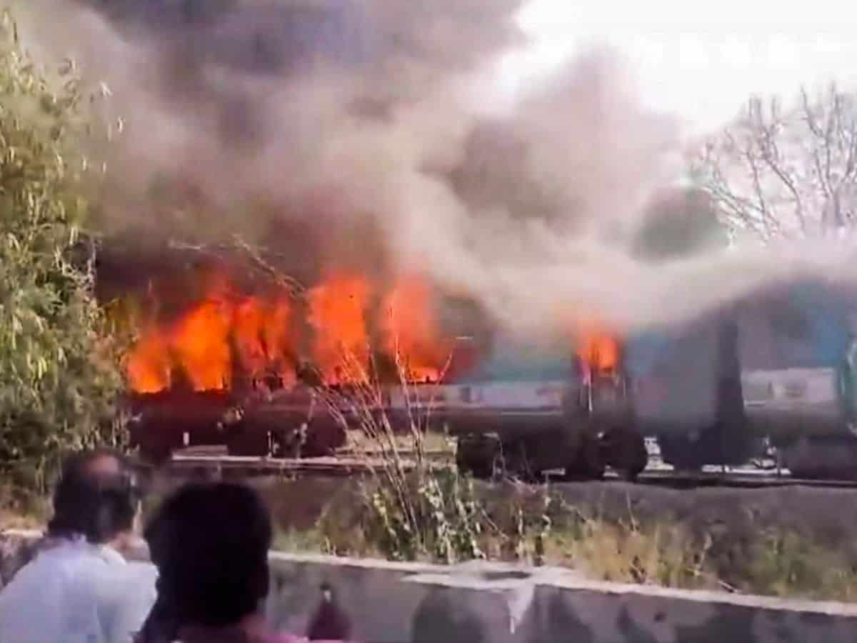A firefighter inside a charred coach of the Taj Express after a fire broke out in the train