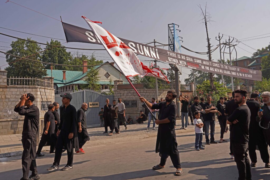Kashmir Shia Muslims waving flags with different Islamic sayings/messages during the traditional Procession on 8th of Muharram on Monday in Srinagar.
