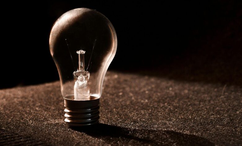 Photo of a bulb in darkness for power cuts in Hyderabad