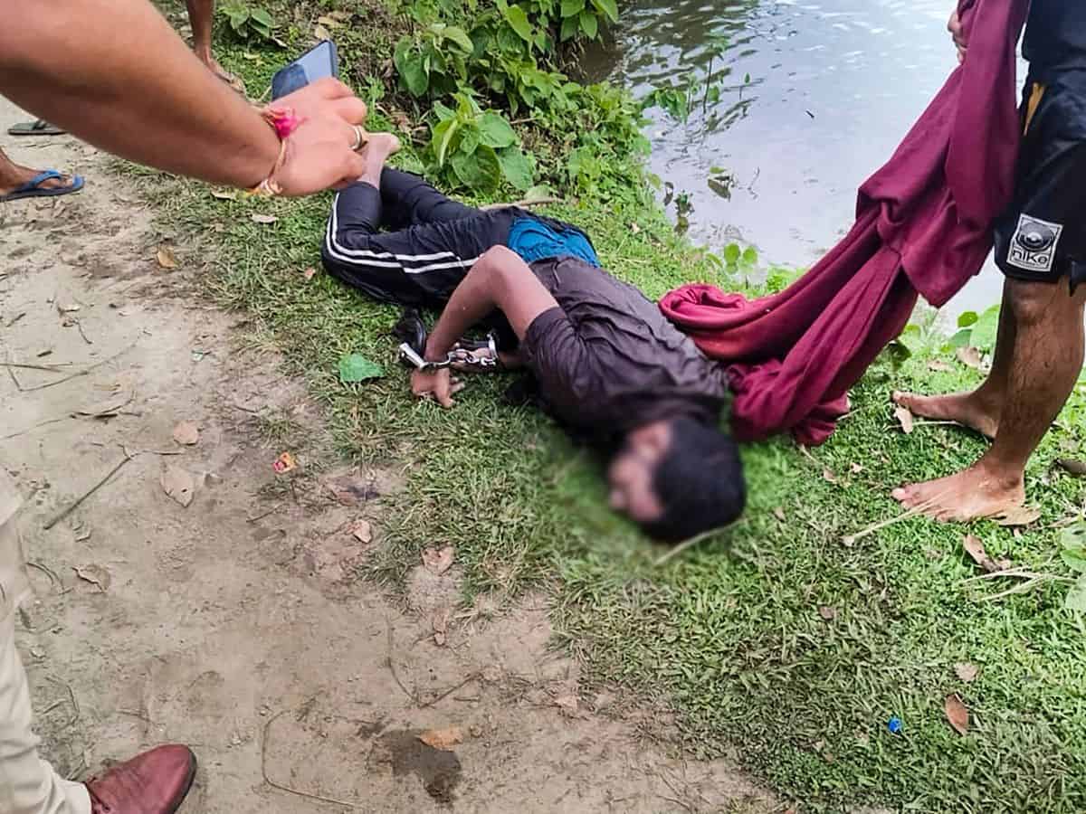 Body of prime accused in the alleged rape of a minor girl after being recovered from a pond, at Dhing, in Nagaon district, Saturday, Aug. 24, 2024. The accused allegedly escaped from police custody, jumped into a pond and died on Saturday morning at Dhing in Assam's Nagaon district, an official said. (PTI Photo)