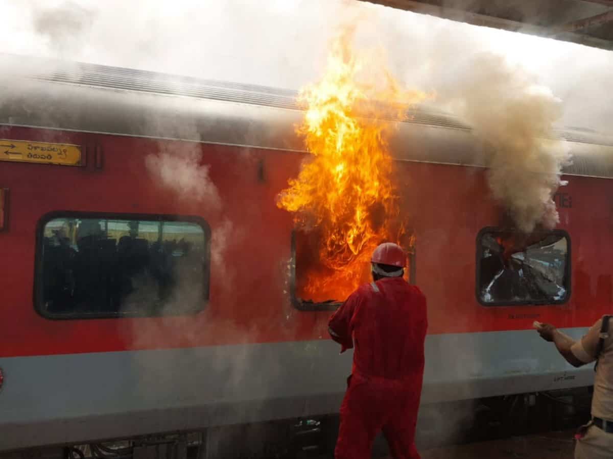train fire A firefighter tries to douse a fire that broke out in the Tirumala Express at Visakhapatnam railway station, Sunday, Aug. 4, 2024. (PTI Photo)