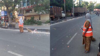 GHMC sweepers face the difficult task of clearing coloured paper strips from the city roads on Wednesday morning.