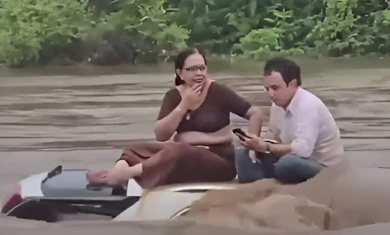 Watch: Two swept into river wait for hours on car top for help in Gujarat