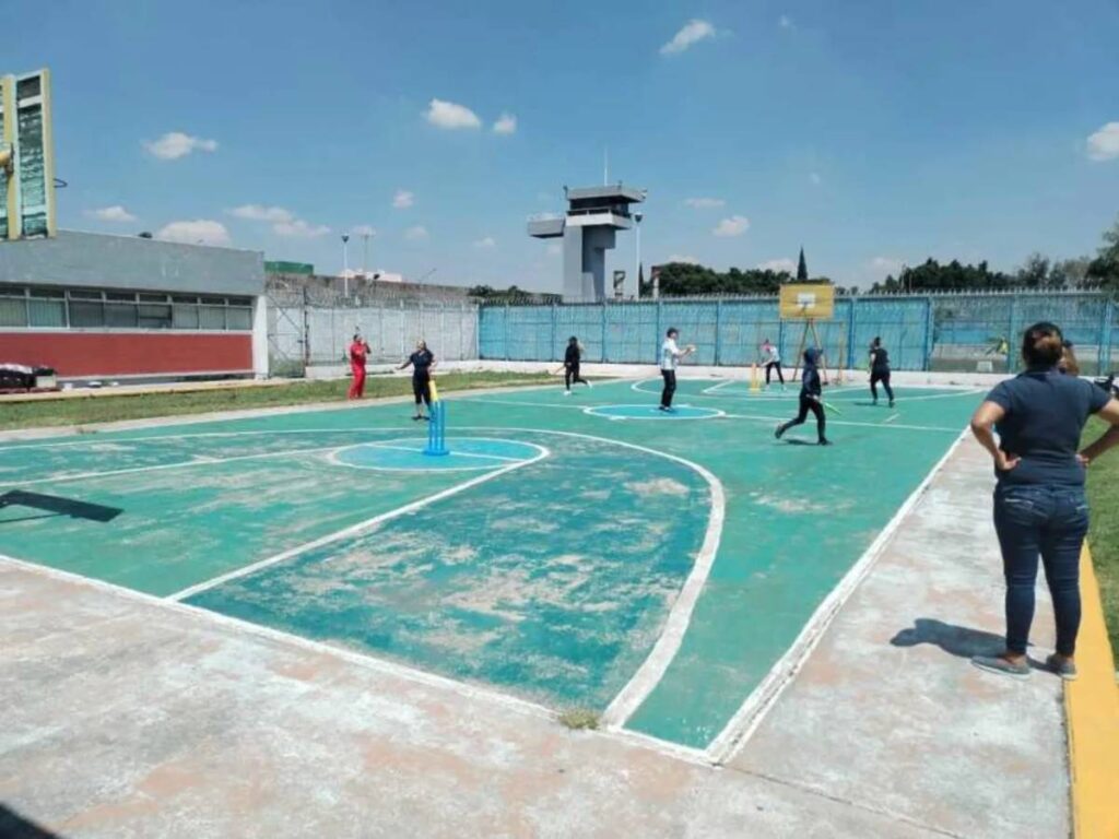A basketball court does double duty as a cricket pitch at the Tepepan Women's Social Rehabilitation Center in Mexico City • Mexico Cricket Association