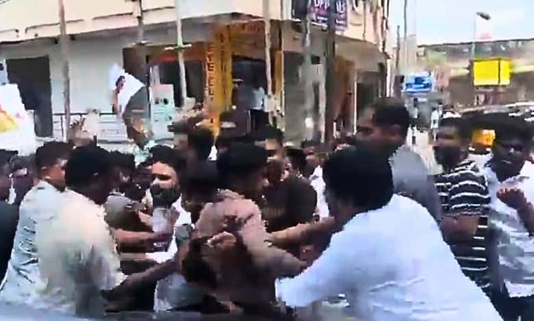 Watch: Congress worker climbs on KTR’s car to block convoy