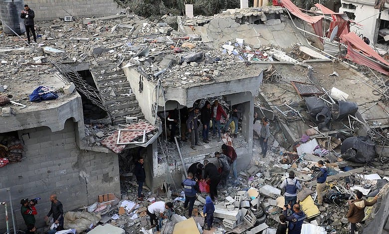 People search for survivors in the rubble of destroyed buildings following an Israeli airstrike.