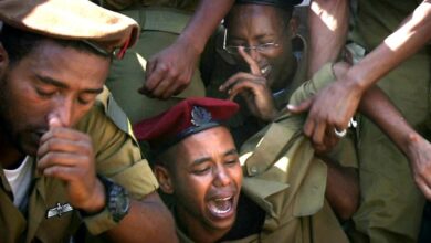Relatives and friends of Staff Sgt. Moshe Malko Ambao cry during his funeral at the military cemetery in the city of Lod