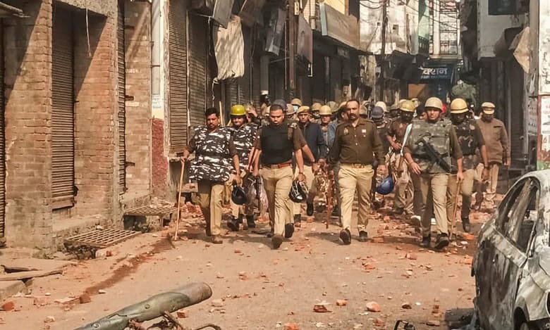 Police and security personnel interact with locals protesting during a second survey of the Jama Masjid, claimed to be originally the site of an ancient Hindu temple