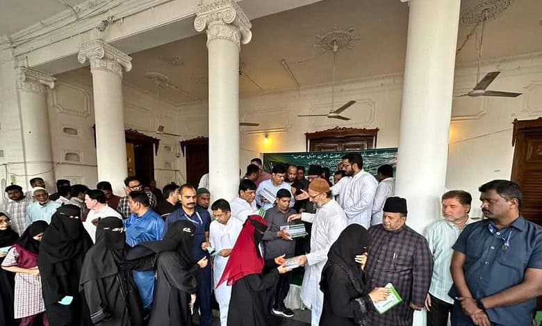 Asaduddin Owaisi distributing Urdu guides to the students in Hyderabad