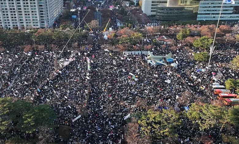 The streets of Seoul were packed with an estimated 145,000 protesters who erupted in cheers as parliament passed a vote to impeach Yeol