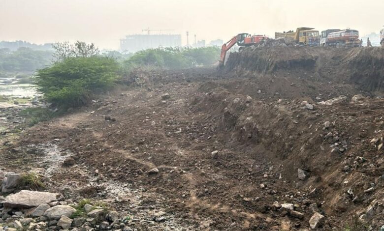 Hyderabad realtors start removing debris from Musi river bed after HYDRAA's intervention in Narsinghi.