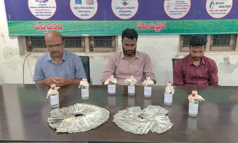 Three municipal officials apprehended by ACB Telangana for accepting a bribe, are seated behind a table