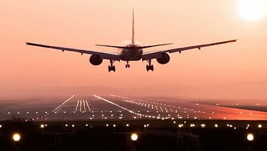 A flight landing on runway of airport.