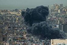 Smoke rises after airstrike hits residential area.