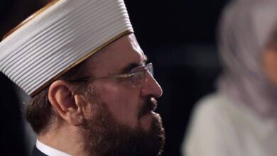 Ali AlQaradaghi, Secretary-General of the International Union of Muslim Scholars (IUMS), wearing traditional Islamic attire and a white turban, captured in a side profile during a formal event or conference.
