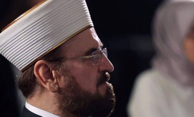 Ali AlQaradaghi, Secretary-General of the International Union of Muslim Scholars (IUMS), wearing traditional Islamic attire and a white turban, captured in a side profile during a formal event or conference.