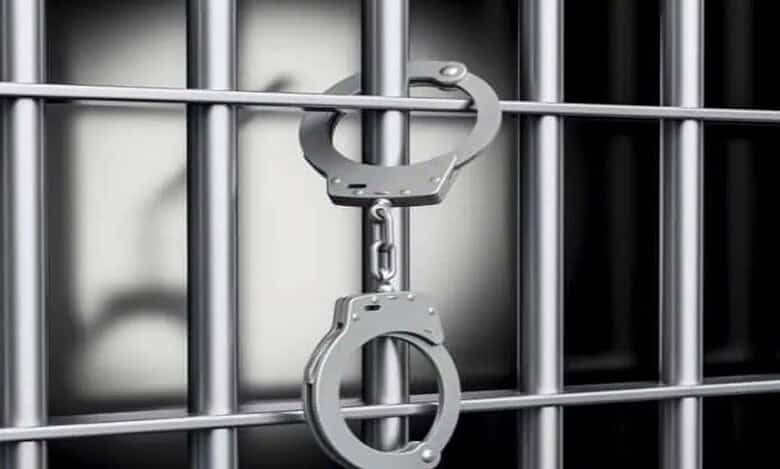 Representational Image of handcuffs hanging from jail