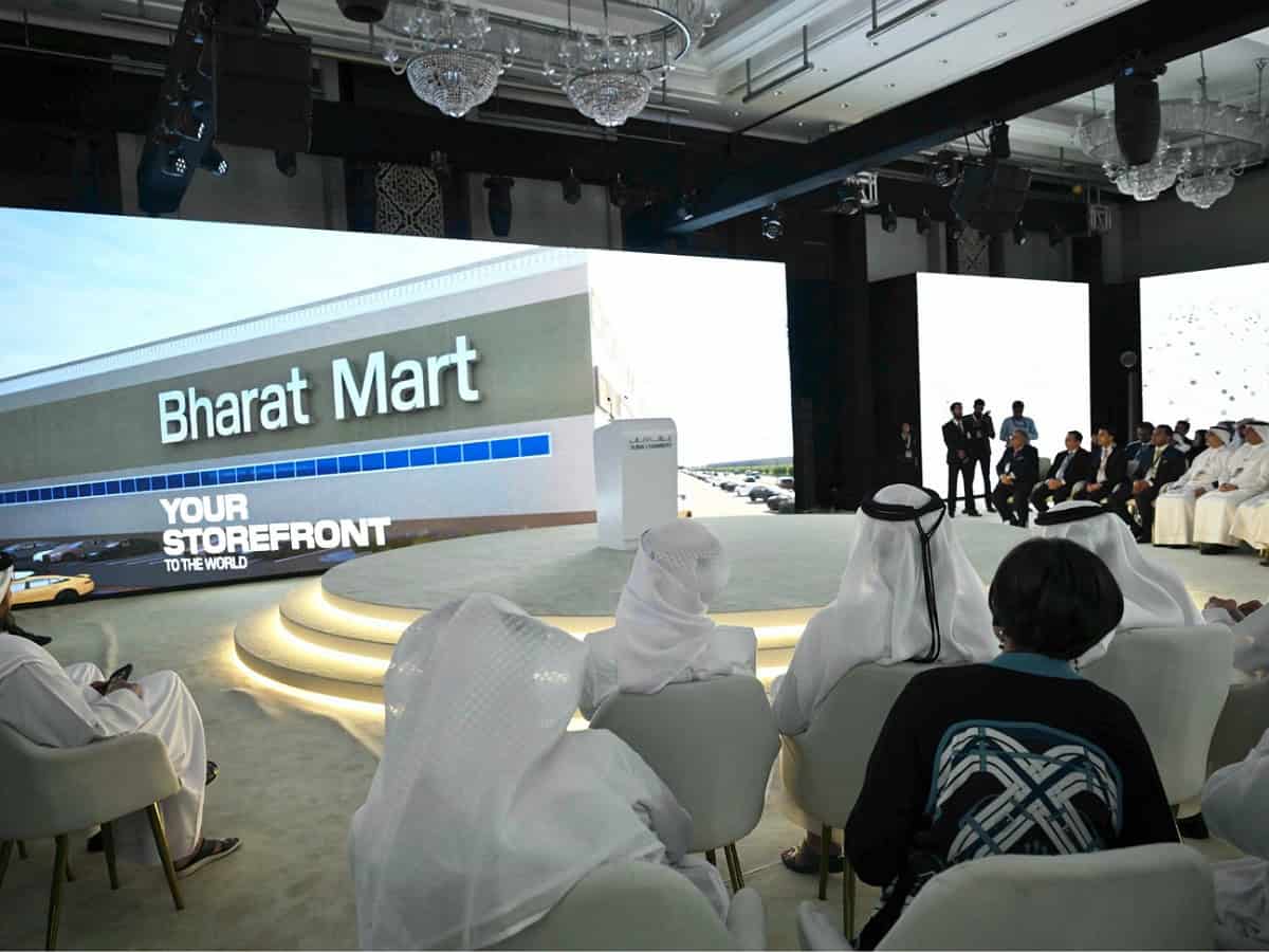 Delegates attend the launch event of Bharat Mart in Dubai, with a large screen displaying the marketplace's name and slogan.