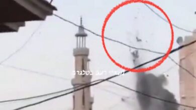 A screengrab from a viral video reportedly showing the aftermath of an Israeli missile strike in Gaza. The image features a mosque in the background, with a red circle highlighting what appears to be bodies being thrown into the air due to the explosion. Smoke is visible rising from the impact site, and electrical wires crisscross the foreground.