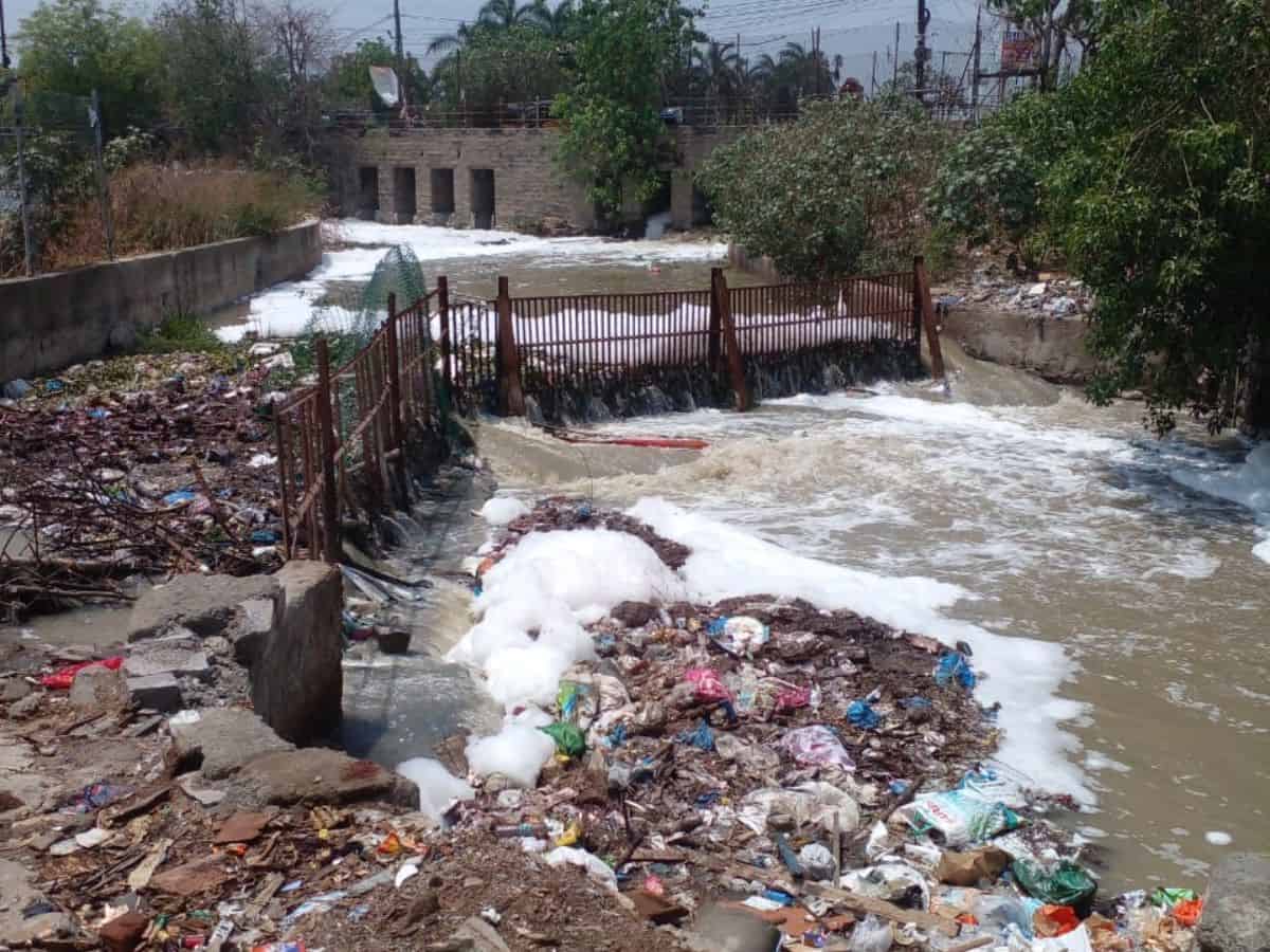Chemical and industrial waste enters Saroornagar lake during rains on Thursday.