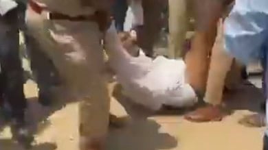 The image shows a Dalit man being dragged by police in half-naked condition, on April 14, 2025.
