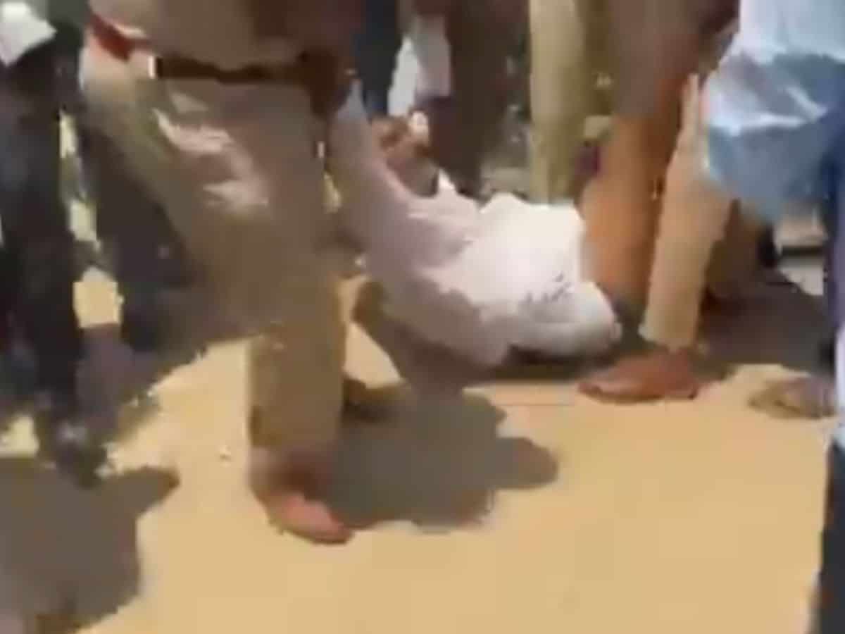 The image shows a Dalit man being dragged by police in half-naked condition, on April 14, 2025.