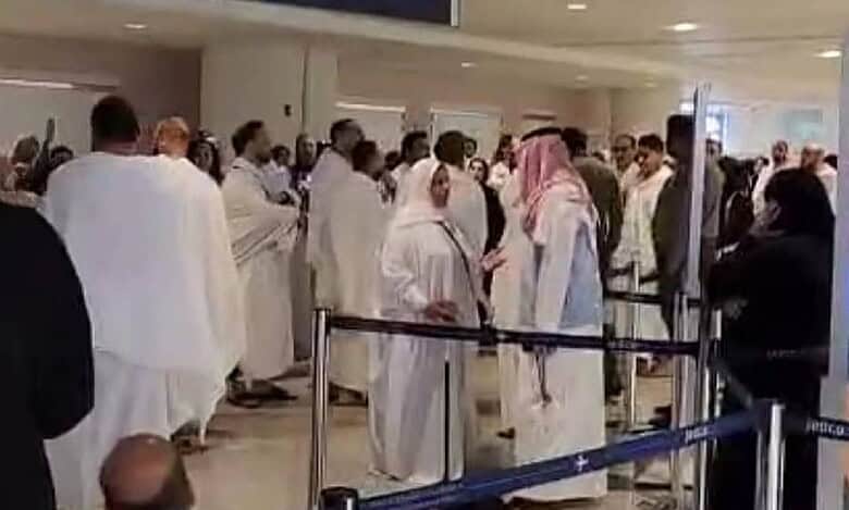 Dozens of Egyptian pilgrims in ihram attire stand and protest inside King Abdulaziz International Airport in Jeddah after being detained for attempting to perform Umrah without valid Haj permits