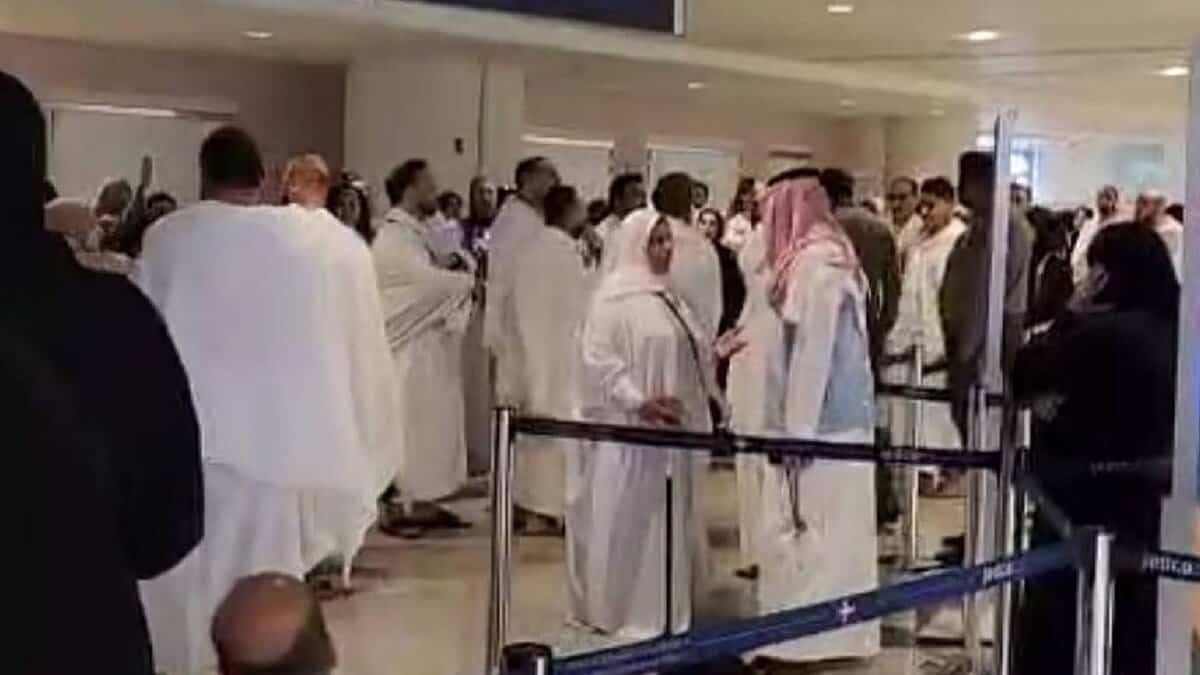 Dozens of Egyptian pilgrims in ihram attire stand and protest inside King Abdulaziz International Airport in Jeddah after being detained for attempting to perform Umrah without valid Haj permits