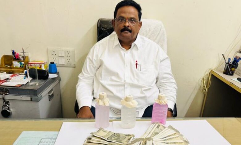 GHMC official Vipperla Srinivas sitting down after a chemical test confirmed he accepted a ₹70,000 bribe