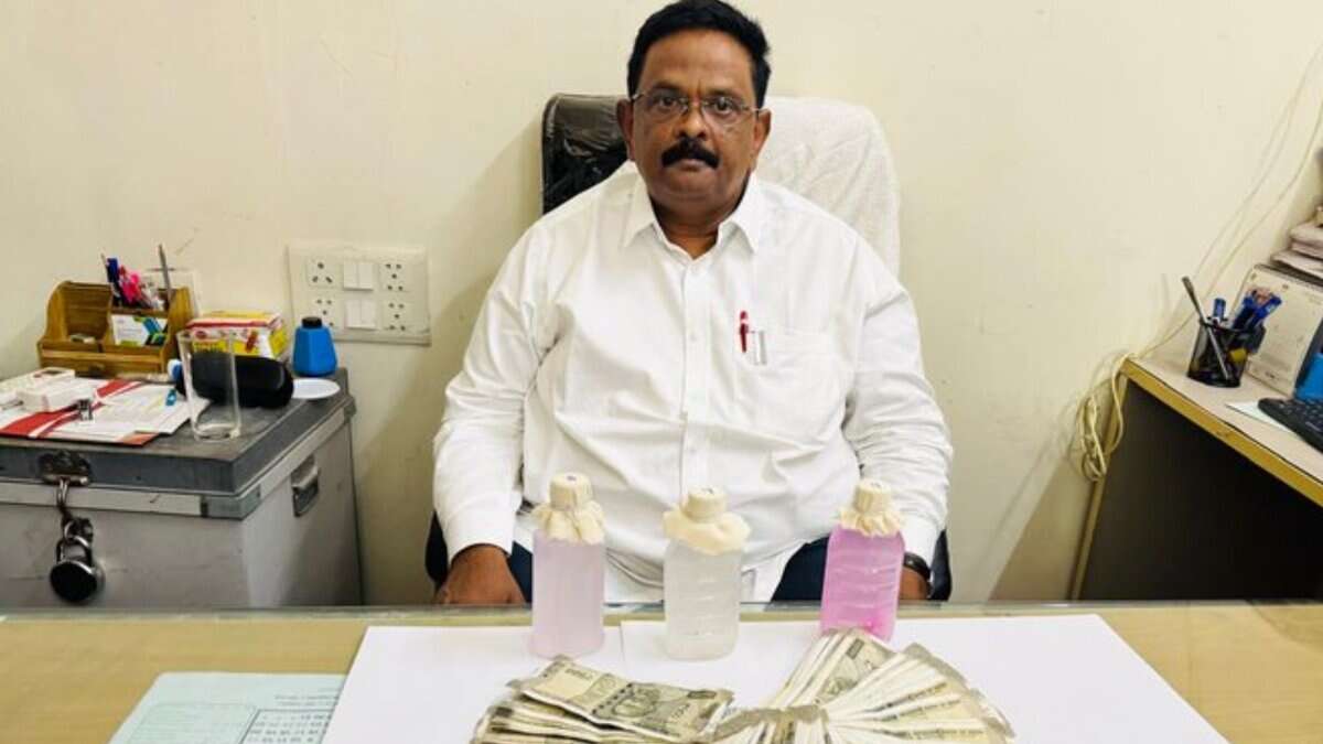 GHMC official Vipperla Srinivas sitting down after a chemical test confirmed he accepted a ₹70,000 bribe