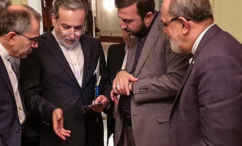Iranian Foreign Minister Abbas Araghchi (second from left) engaged in conversation with members of his delegation during a break in meetings in Muscat.