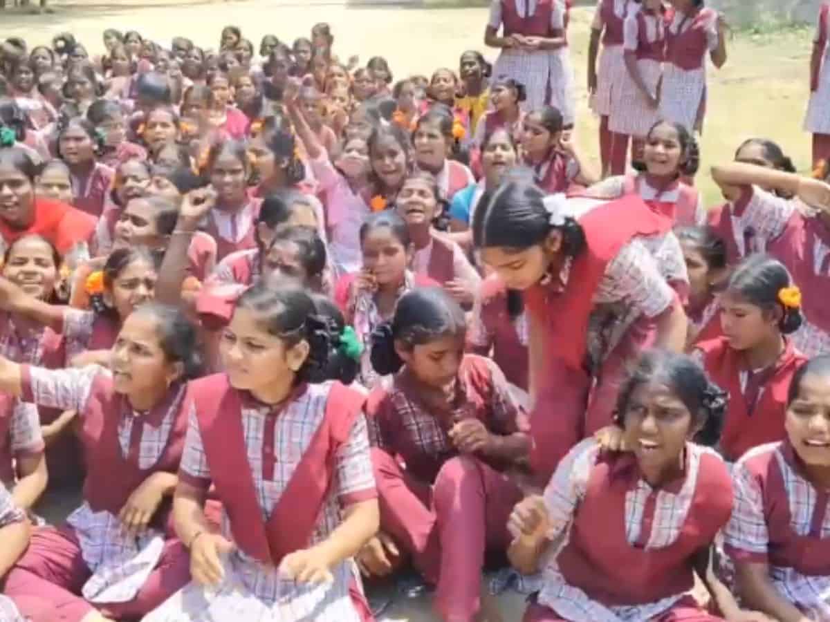 The image shows KGBV Nagarkurnool students protesting in their school, demanding the removal of their English teacher from service on April 15, 2025.
