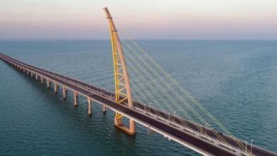 Aerial view of Jaber Bridge in Kuwait, an architectural marvel spanning the sea with a striking cable-stayed design.