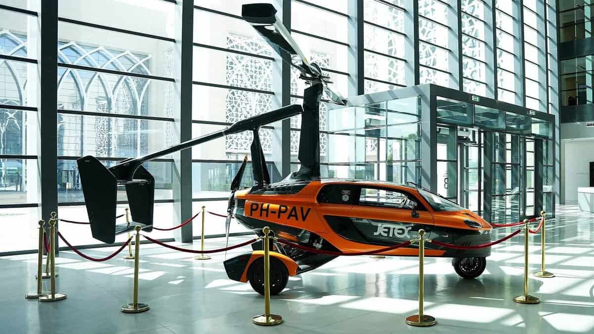 PAL-V Liberty flying car on display indoors at Sharjah Research, Technology and Innovation Park.