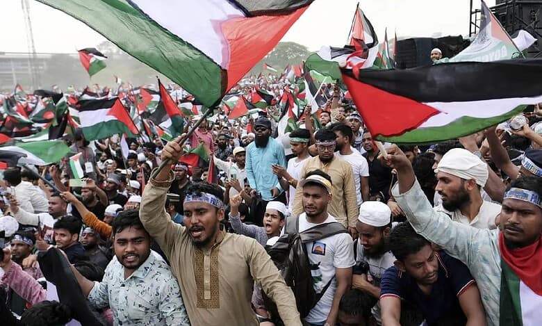 Thousands of protesters wave Palestinian flags during a mass rally against Israel in Dhaka, Bangladesh, showing solidarity with Palestinians amid ongoing conflict.
