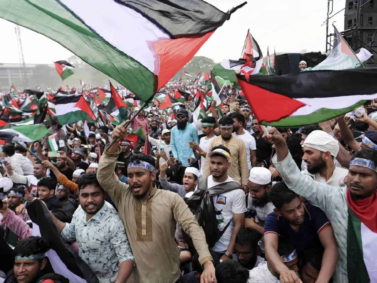 Thousands of protesters wave Palestinian flags during a mass rally against Israel in Dhaka, Bangladesh, showing solidarity with Palestinians amid ongoing conflict.