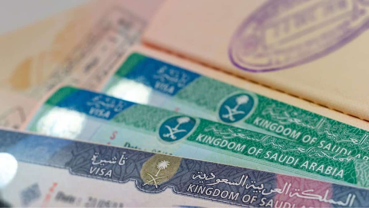 Close-up of multiple Saudi Arabian visas inside a passport, showing official visa stamps issued by the Kingdom of Saudi Arabia.