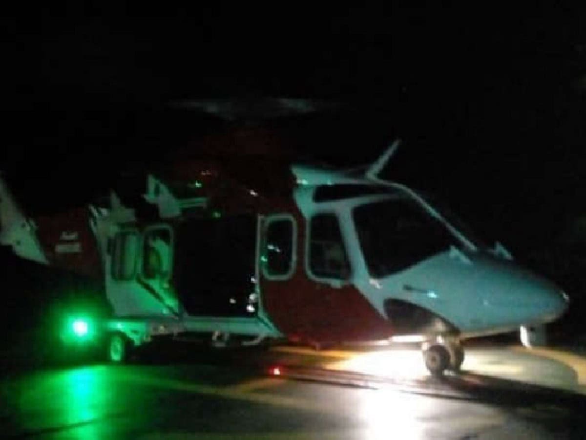 Representative image of rescue helicopter on helipad in the dark, ready for take-off.