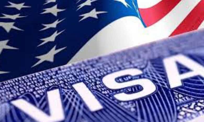 Close-up of a United States visa document with the American flag in the background, symbolising US immigration or travel authorisation.