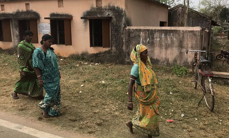 The image displays women villagers walking in Telangana