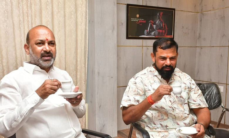 The image displays BJP leaders Bandi Sanjay and T Raja Singh having a cup of tea. April 12, 2025