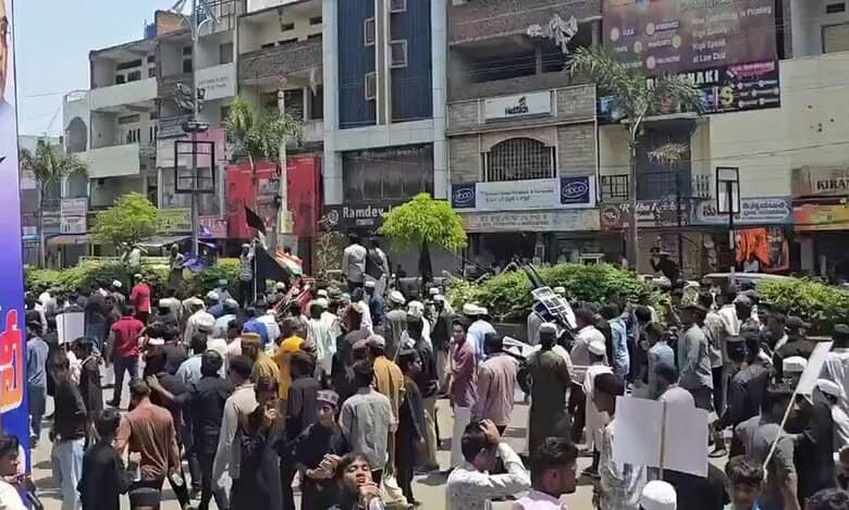 The image displays many men in Hyderabad protesting against the Waqf Amendment Act. April 13, 2025