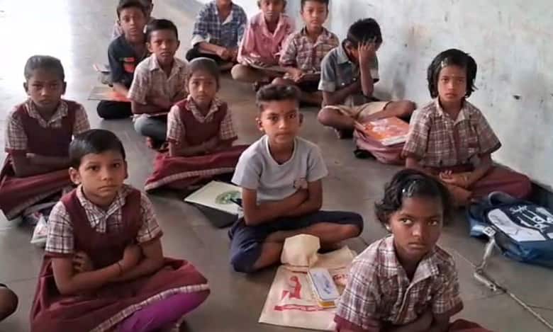The image displays students of a government primary school in Adilabad, Telangana.