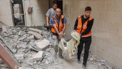 Palestinian medics transport the body of a victim following Israeli attacks on apartments in a residential building in Gaza City [Omar al-Qattaa/AFP]