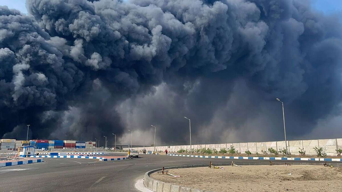 The image shows thick smoke billowing from an Iranian port after a blast was reported, leaving over 400 injured.