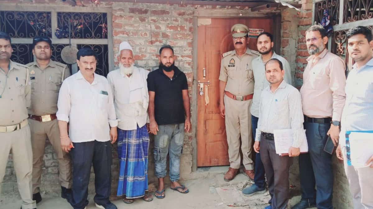 The image displays a picture of district magistrate of Shravasti along with police official after demolishing
