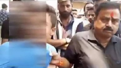 The image displays a blurred picture of a teenager being whisked away by a man who has a saffron tikal on his forehead in Aligharh.