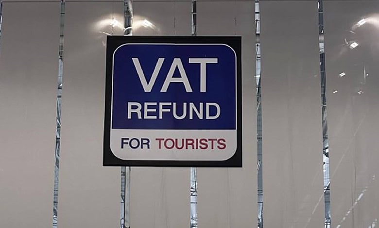 VAT refund sign for tourists displayed at an international airport, indicating tax reclaim services available for non-resident shoppers.