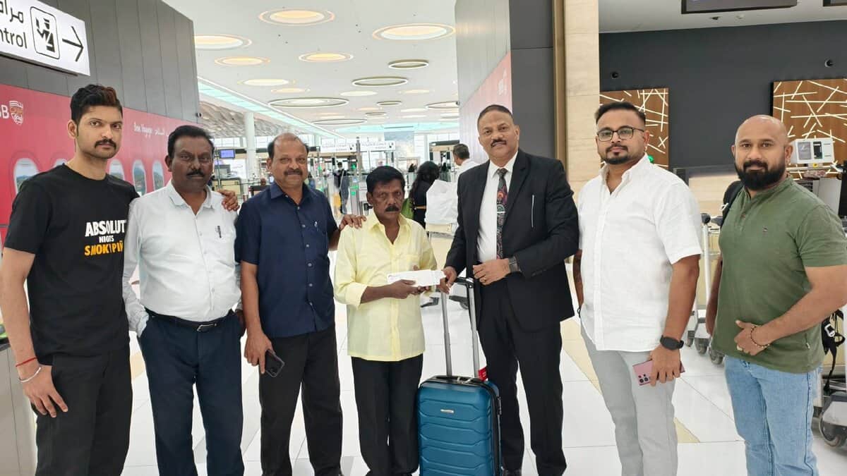 Gopalan Chandran, an Indian expatriate stranded for 42 years in Bahrain, seen at the airport with supporters and embassy officials before boarding his flight home to Kerala.